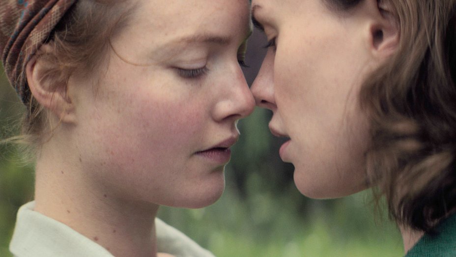 a close-up on Lydia and Jean about to kiss