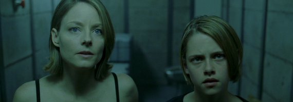 This image is from Panic Room. Jodie Foster is on the left, and a young Kristen Stewart is on the right. They are both looking the camera's direction. 