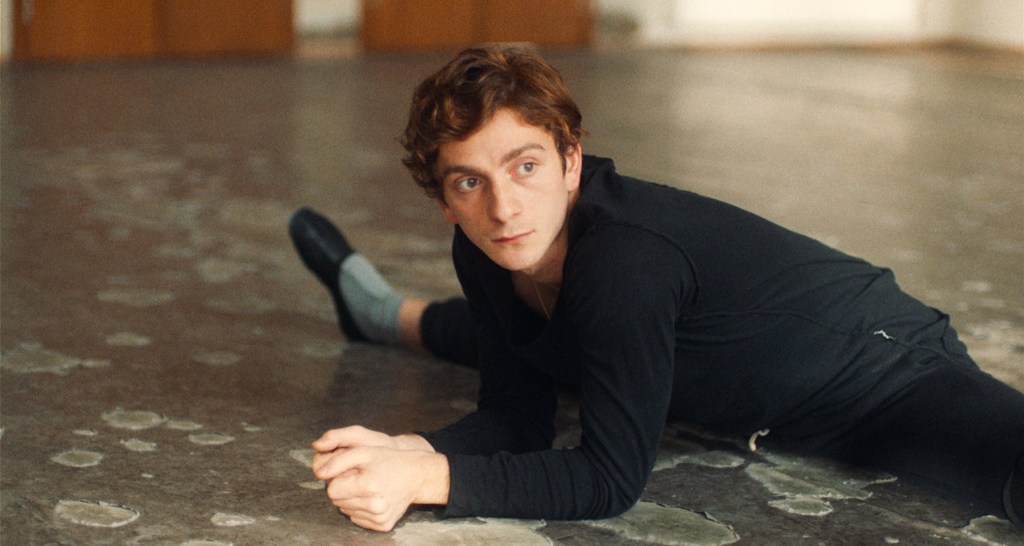 Merab stretches out into a split a dance studio.