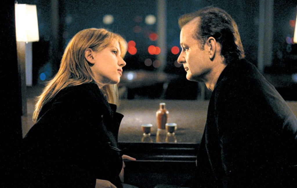 Screencapture from Lost in Translation. A man and a woman face each other at a bar.