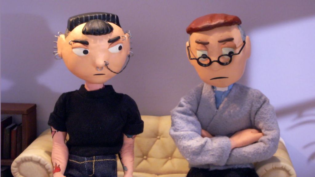 Two Plasticine figures sit side by side. One is a goth, covered in tattoos and piercings. This is Stephanie. The other is a vicar.