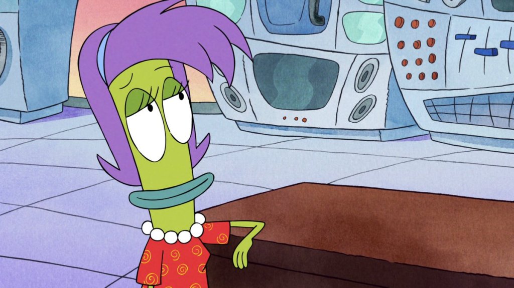 Rachel has her arm on a desk. She is a thin green woman with purple hair.