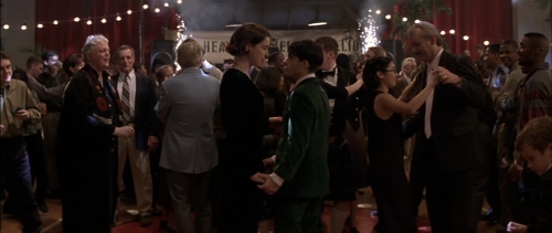 Screencapture from Rushmore. A woman and a teenage man dance at a busy party. 