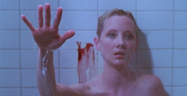 Marion is in the shower. There is blood on the wall behind her. She is holding our her hand.