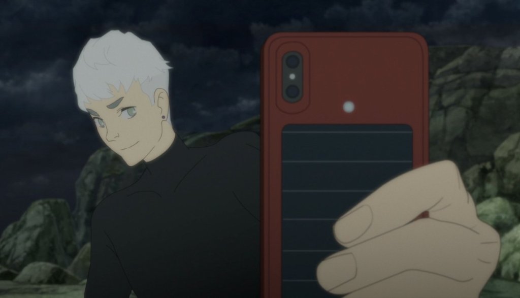 YouTuber Kaito smiles against a rocky backdrop whilst holding out his phone