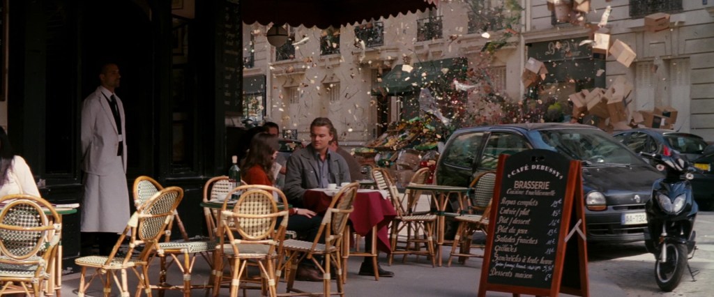 Signature shot from Inception, where Ellen Page playing Ariadne and Dom are dreaming, sitting at a cafe terrace, when everything around them starts blowing apart