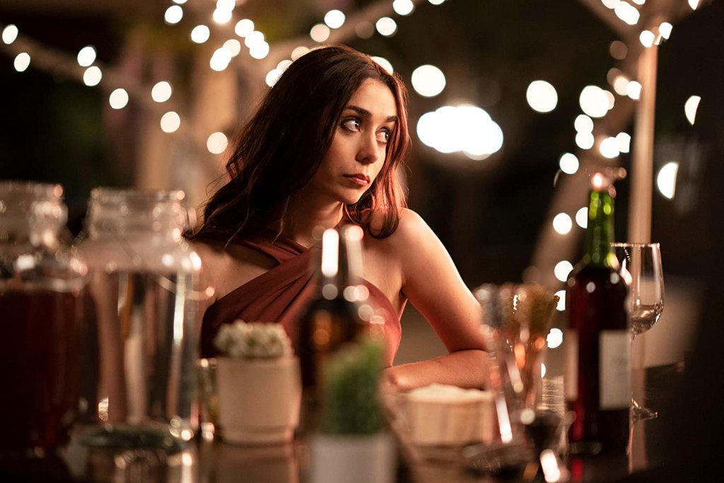 Picture of Cristin Milioti as Sarah sitting at a table.