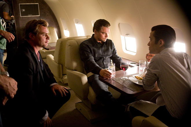 Christopher Nolan directing and talking with Leonardo DiCaprio and Joseph Gordon-Levitt on the set of Inception