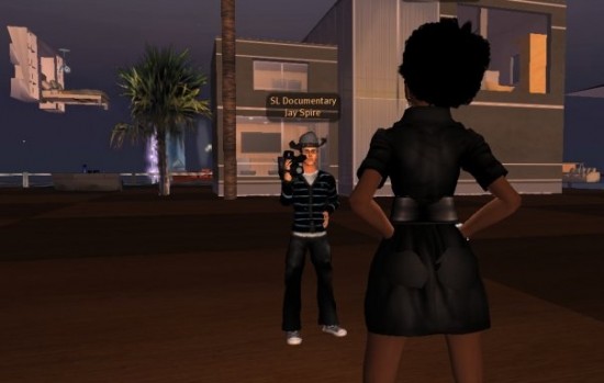 Image shows two avatars inside the game Second Life, one of whom is filming the other.