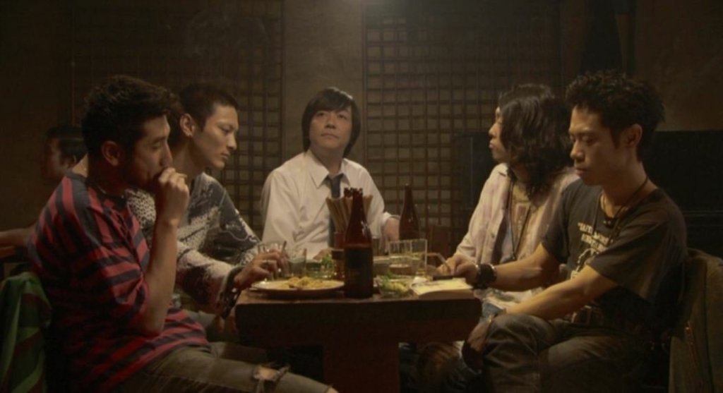 The band and manager behind the song 'Fish Story' sit reflecting, in various states, on their performance