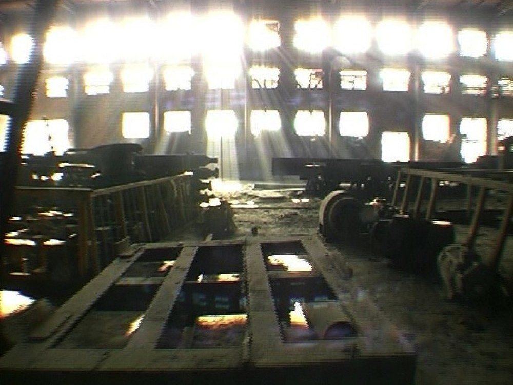 Image of light pouring into a derelict factory.