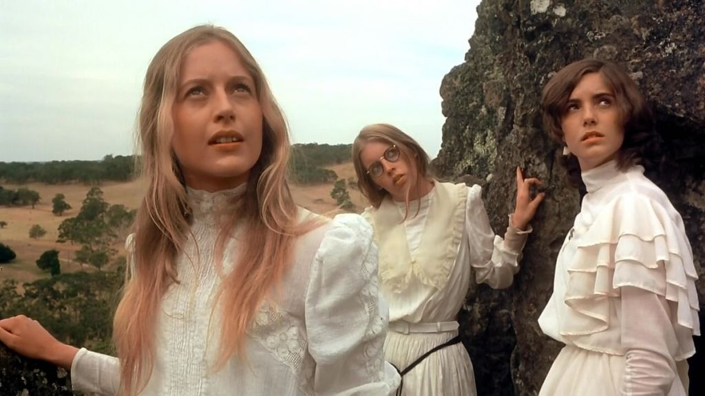 Left to right, Miranda (Anne-Louise Lambert), Marion (Jane Vallis), and Irma (Karen Robson) ascend Hanging Rock.