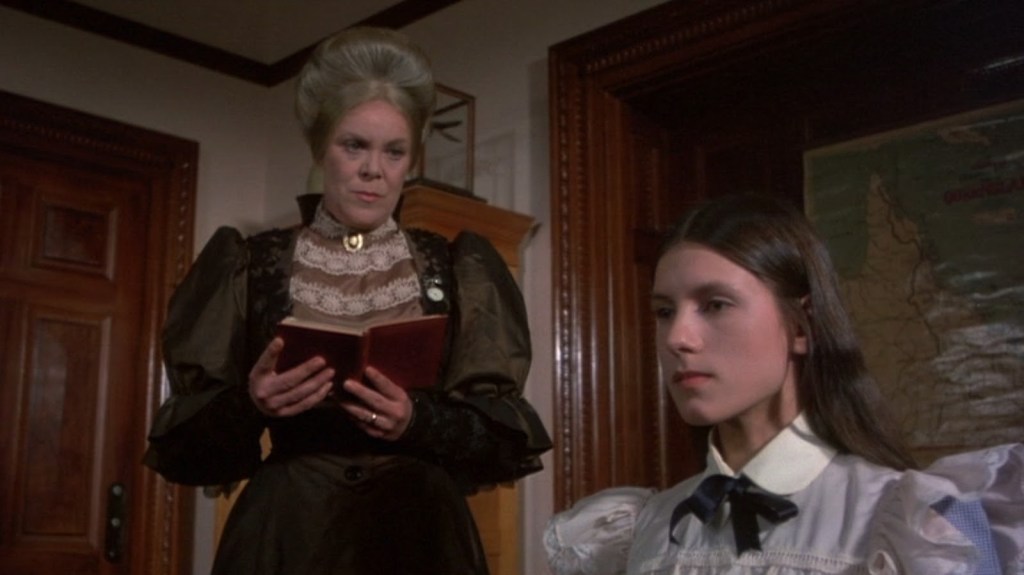 Sara (Margaret Nelson) is quizzed on her poetry by schoolmistress Mrs Appleyard (Rachel Roberts)