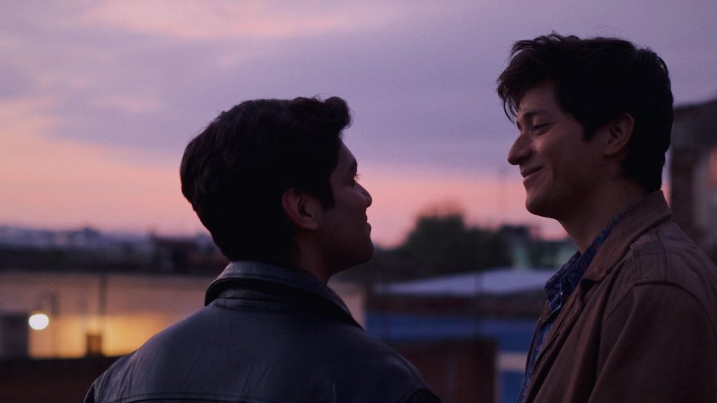 Iván and Gerardo gaze at each other as the sun rises in the distance.