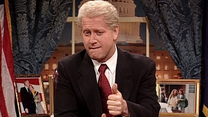 Darrell Hammond bites his lip and sticks up a thumb in his portrayal of then-president Bill Clinton on SNL