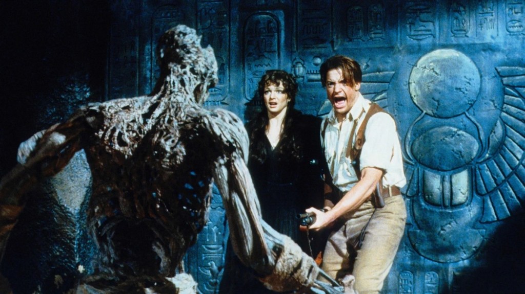 Rick and Evelyn scream and back up against a wall as the rotten carcus of the mummy approaches them.