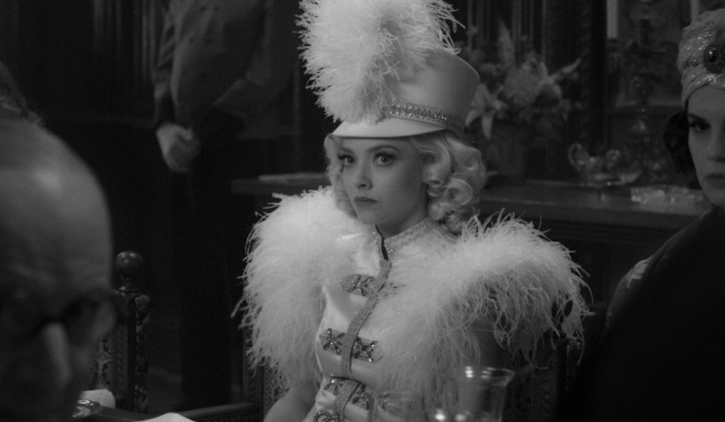 Amanda Seyfried in an elaborate feather costume.