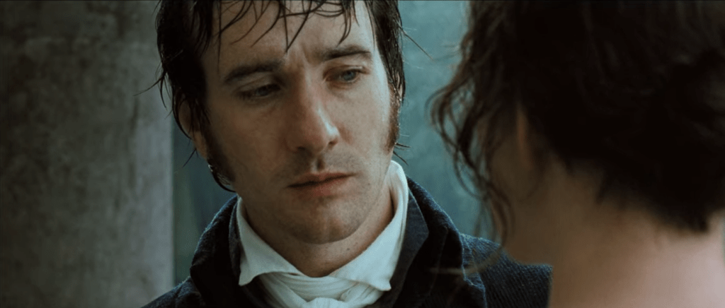 In the rain and after proposing to her, Darcy looks down longingly at Elizabeth.