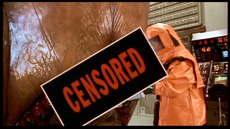 A censored sign obscures a hazmat-suited scientist experimenting on a large slug-like creature by shoving a harpoon into its mouth.