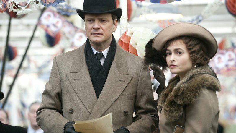 A man wearing a top hat holds a series of papers. A woman stands next to him and comforts him.