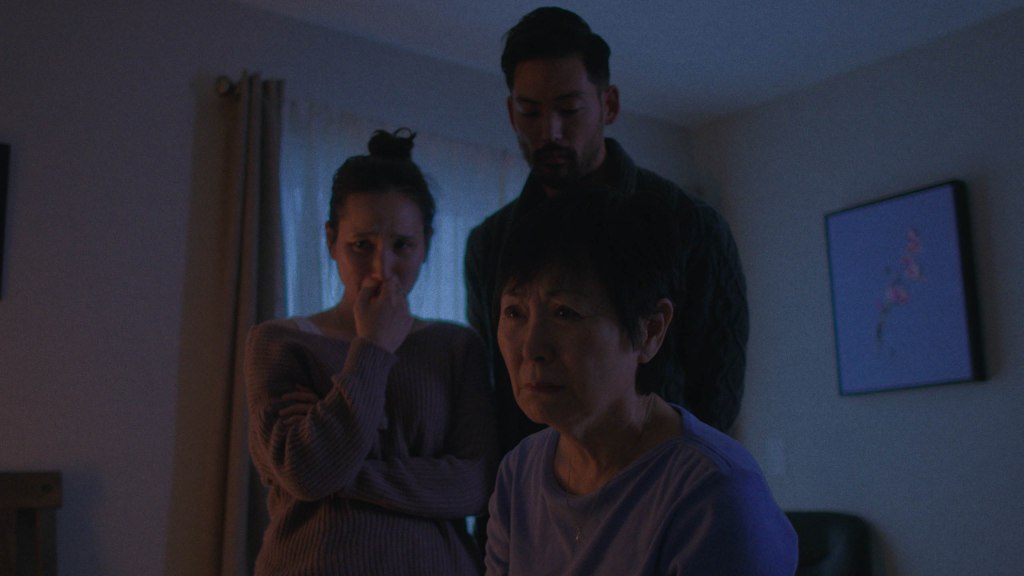 A family tearfully gathers around their dying father's bedside.