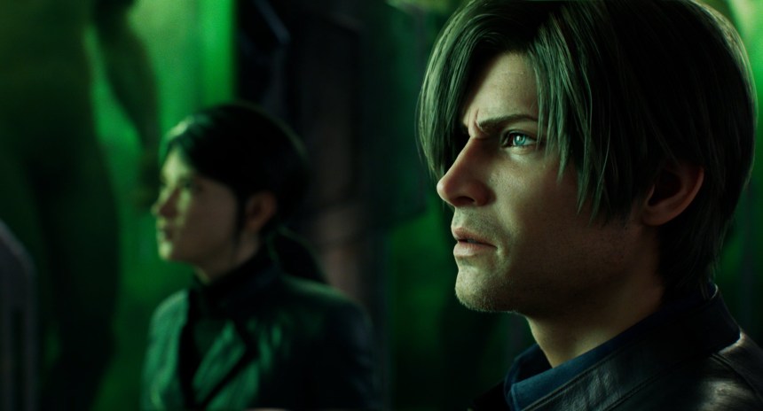 Leon Kennedy, with short hair and stubble, is seen in profile view. Shen May is in a jacket and out of focus in the background. They're observing something, their environment lit by a green tint