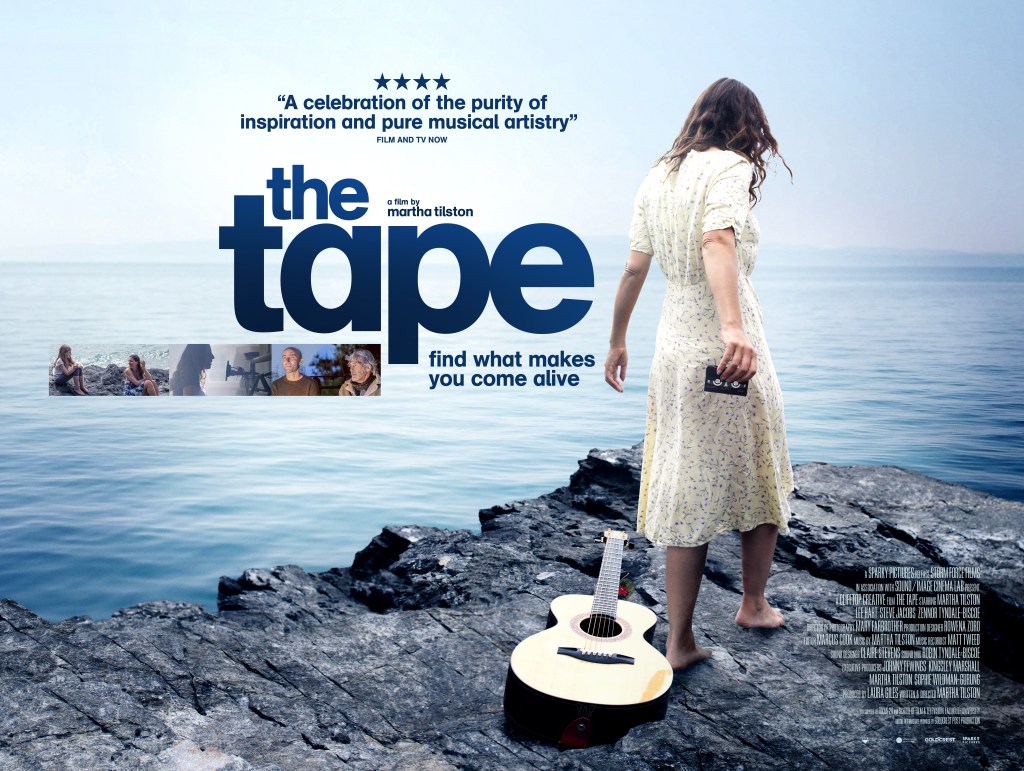 A poster for the film 'The Tape'. A woman faces away from the camera wearing a long floral dress with short sleeves and holding a cassette tape out. A guitar rests on the rocks behind her, and she faces the sea. A four-star review of the film is featured, as well as the film's title in big bold letters with stills from the film underneath. The poster also includes the tagline and the tagline "find what makes you come alive"
