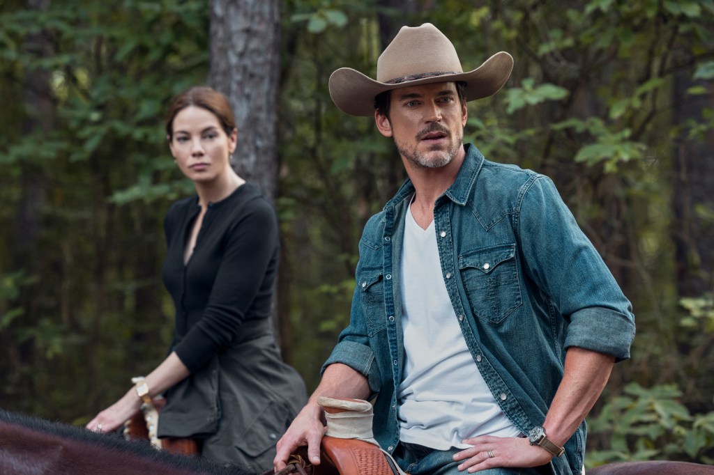 Michelle Monaghan as Gina McCleary and Matt Bomer as Jack in a still from 'Echoes'. They are seen riding horseback in the woods.