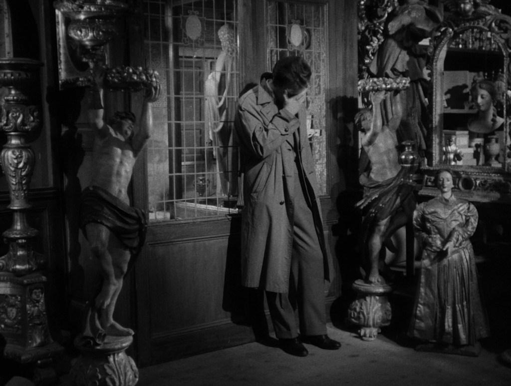 Still showing Fausto at work. His head is down in his hand, as if he had just done something he shouldn't have done and now worry about the consequences. He is surrounded by various historical sculptures and artefacts. 