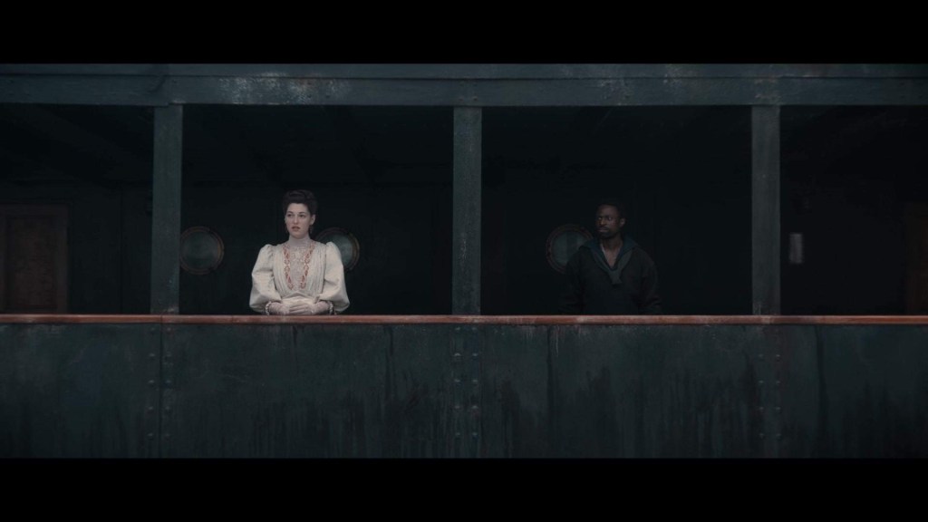 Clémence and Jérôme meeting on the steamship for the first time. Within the frame they are divided by a kind of plate girder used in the ship's design, but it's only temporary as they soon move closer. Clémence is wearing upper-class clothing, a white dress with puffy sleeves and white gloves whilst Jérôme is wearing darker colours and more casual clothing.
