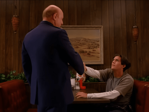 Bobby (Dana Ashbrook) and his father Major Briggs (Don S. Davis) at the Double R Diner in TV series Twin Peaks sharing a sweet moment as they shake hands. 